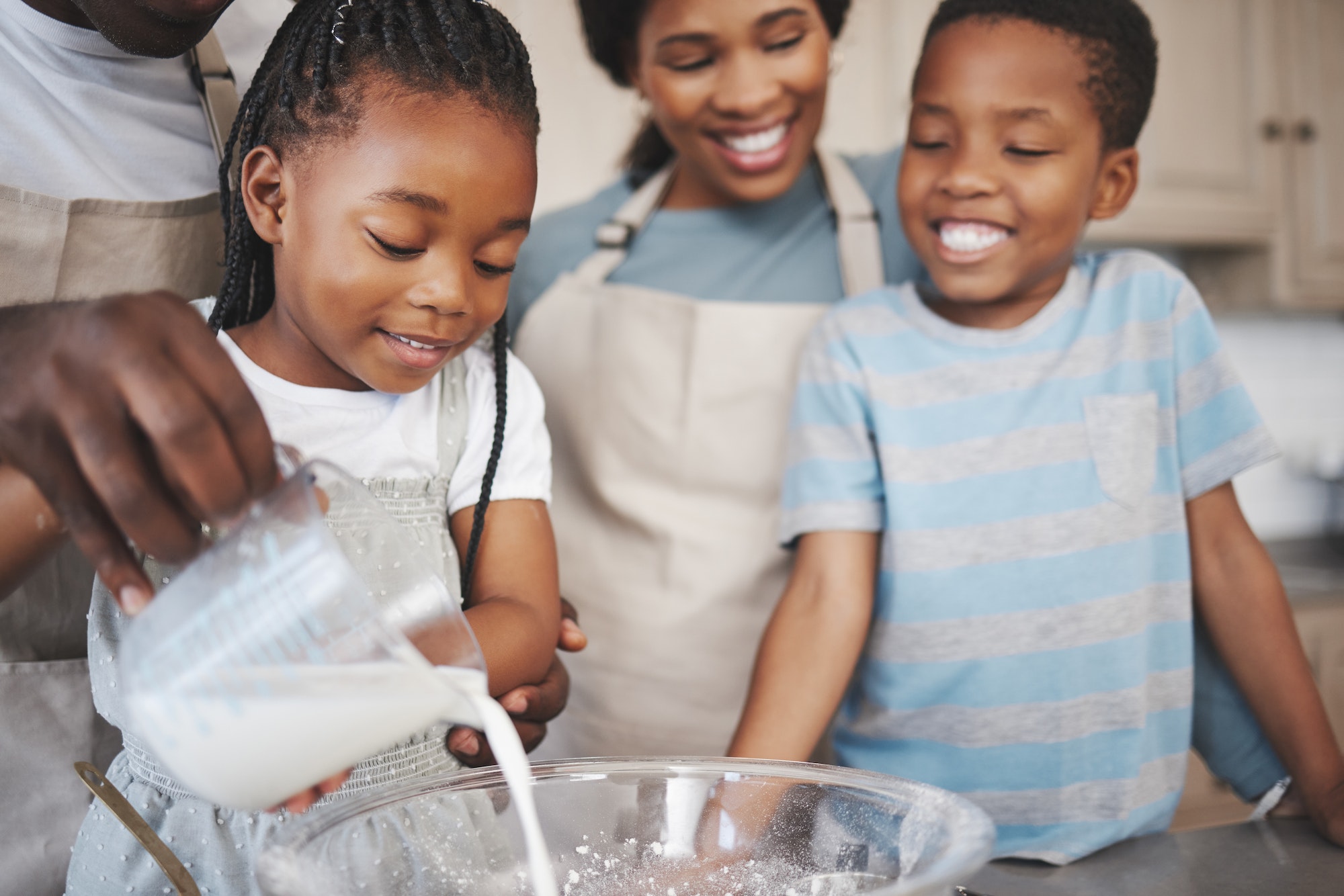 Baking cookies is comforting. Shot of a family baking together in the kitchen.